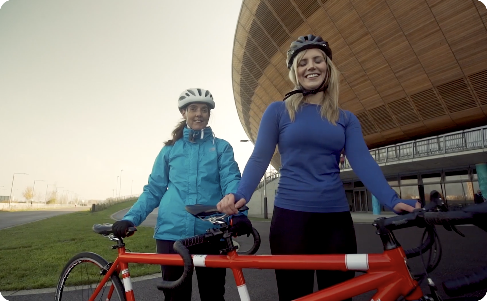 two women standing next to bicycles