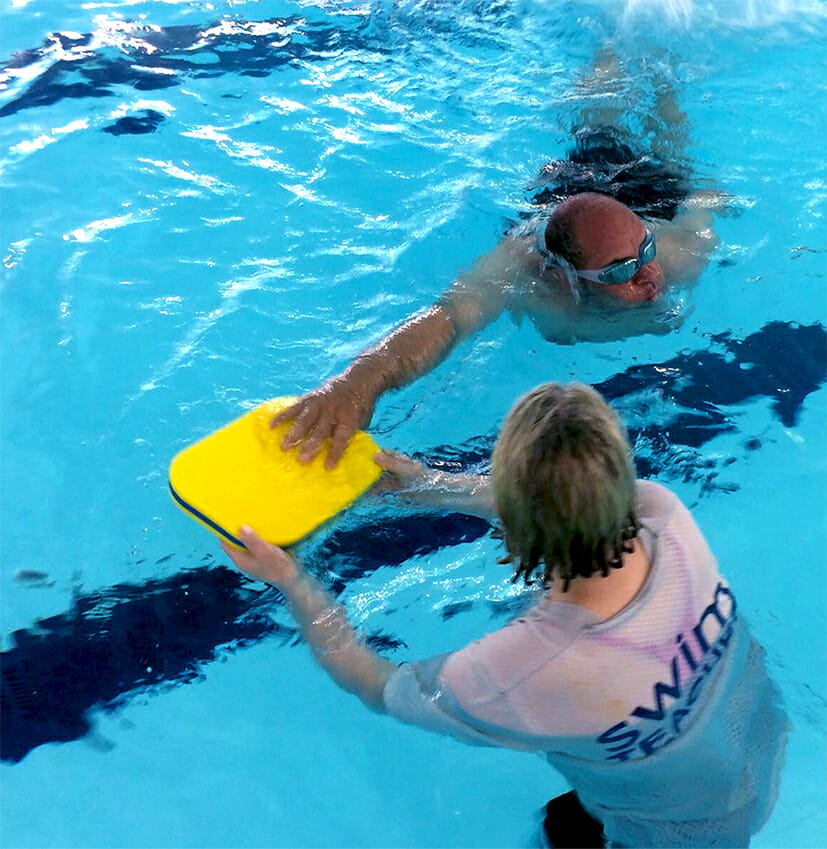 coach and swimming participant in the pool